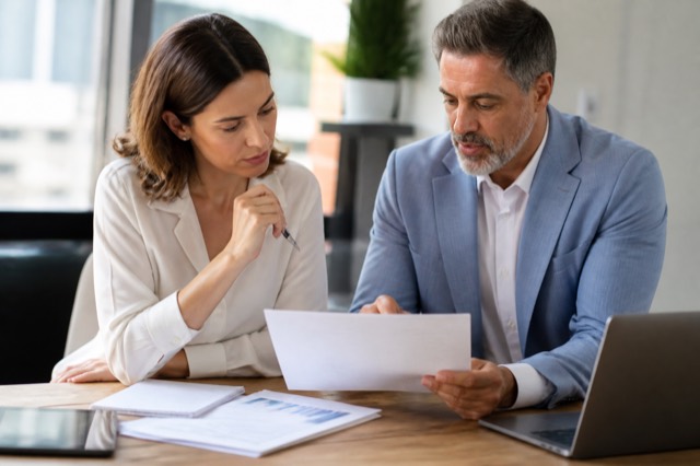 Consultant and client reviewing a clear project proposal together